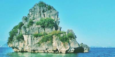Sudden Solitude in Halong Bay Amidst Emerald Waters And Limestone Island
